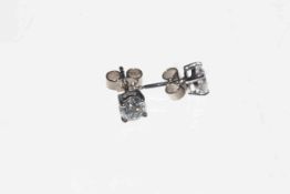 Pair of diamond stud earrings claw set in 18 carat white gold, approximate diamond content 0.