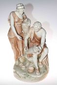 Large porcelain group of male and female water carriers in the style of Royal Dux, 57cm high.