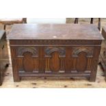 Carved oak triple arched panel front coffer, 62cm by 107cm.