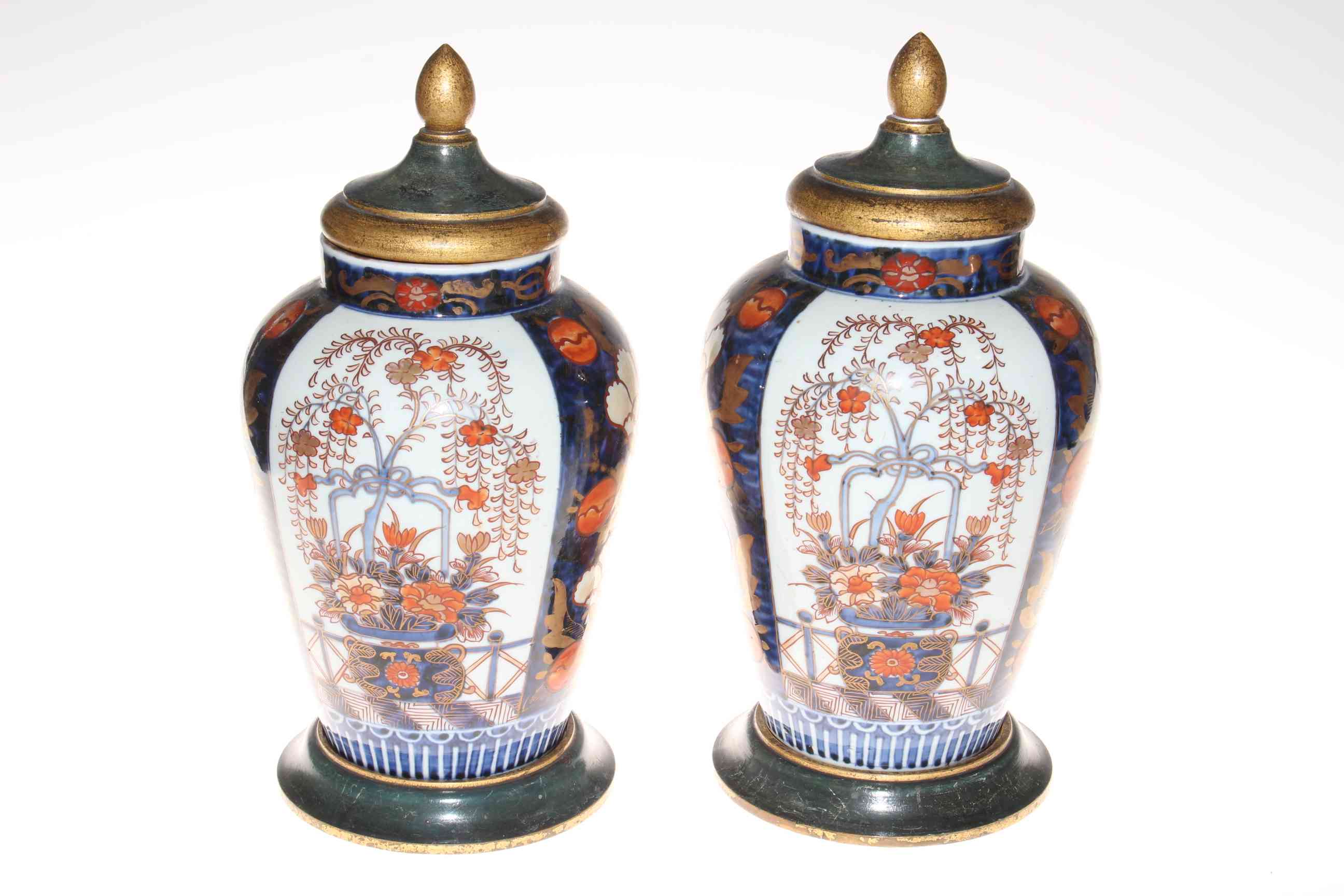 Pair of Imari vases with lids on stands, 35cm.
