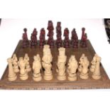 Alice in Wonderland themed chess set with board.