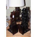 Five pieces of Oriental hardwood including bookends, lamp and figures.