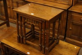 Oak nest of three turned leg tables.