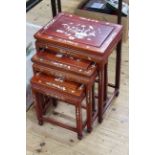 Nest of three Oriental hardwood and mother of pearl inlaid tables, largest 57cm by 44.5cm.
