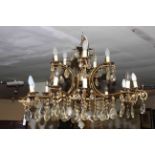 Good two tier fifteen branch ornate gilt metal chandelier with crystal glass drops.