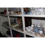 Full shelf of glass, china, brass and horse brasses, annuals, teddy, doll, etc.