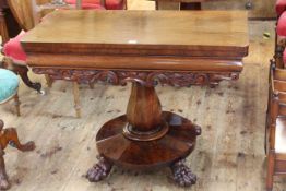 Victorian mahogany fold top tea table on octagonal form to four paw feet, 73cm by 96cm (closed).