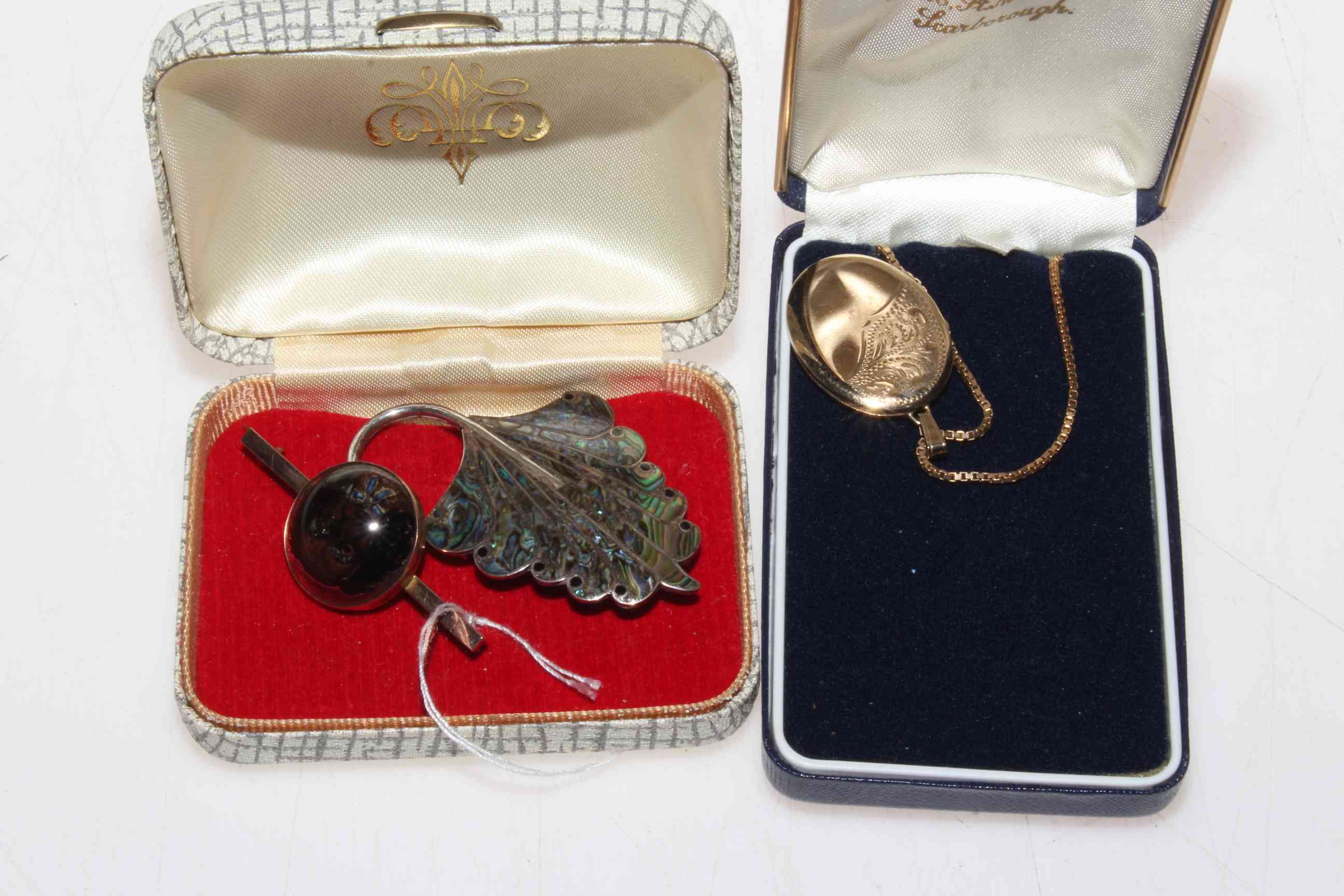 9 carat gold locket and chain, 9 carat gold bar brooch and silver peacock feather brooch (3).