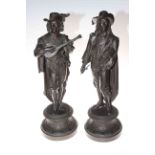 Pair of spelter figures depicting men playing musical instruments, 53cm in height.