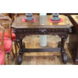 Victorian carved oak centre table having frieze drawer and canted corners,