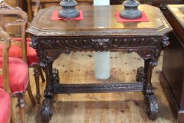 Victorian carved oak centre table having frieze drawer and canted corners,