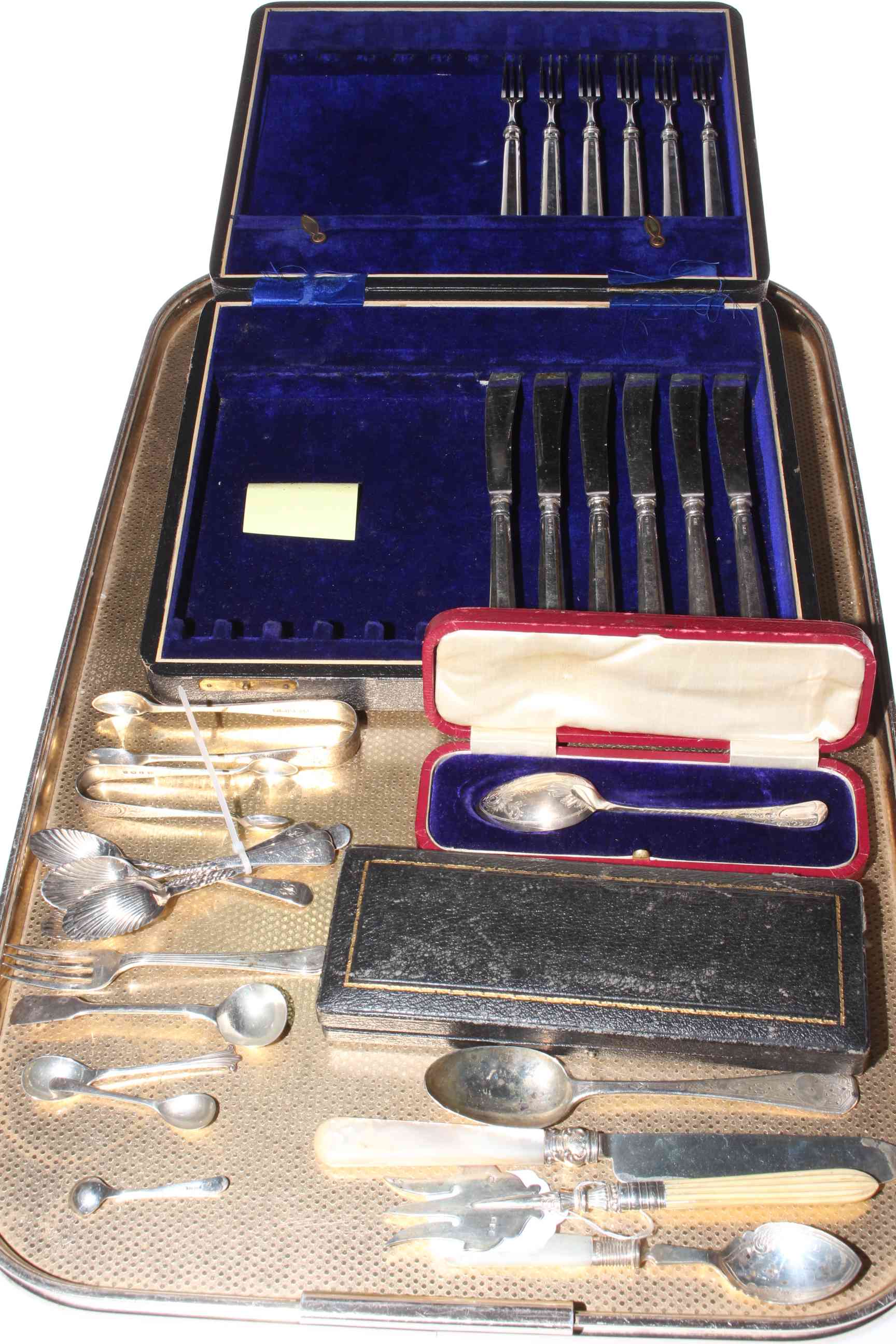 Six silver handled knives and forks, six silver coffee spoons, two pairs of sugar tongs,