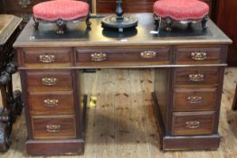 Edwardian mahogany nine drawer pedestal desk, 75cm by 122cm.