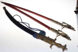 Three Indian swords with felt scabbards.
