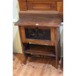 Arts & Crafts oak side table with fall front painted panel door below, 70cm by 61cm.