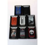 Eight boxed Zippo lighters.