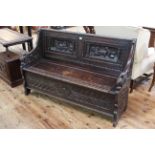 Victorian carved oak box settle, 87cm by 137cm.
