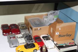 Model cars, badges and magazines.