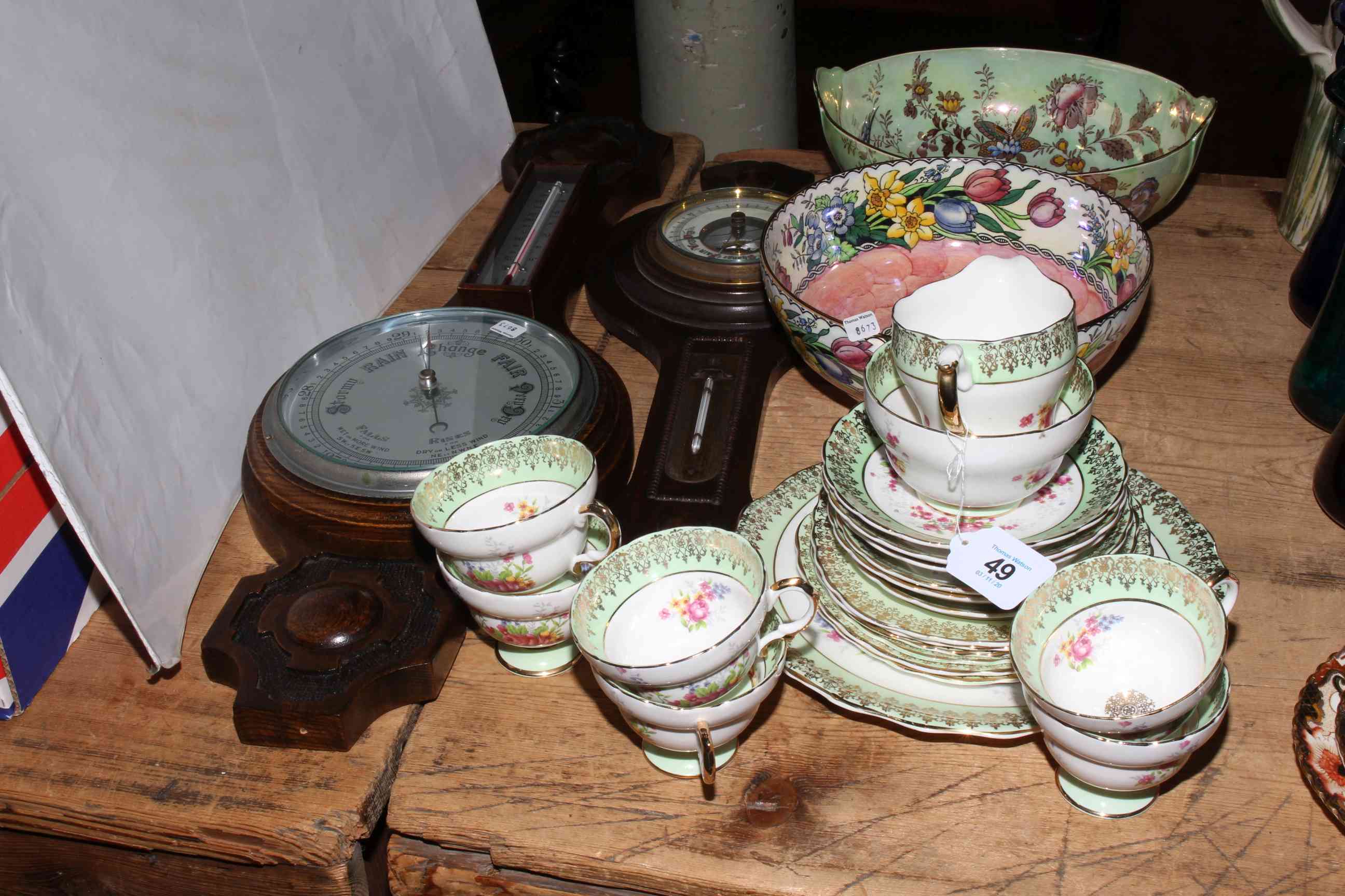 Two Maling lustre bowls, china tea set and two aneroid barometers.