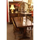 Eight piece Ercol dining room suite comprising shelf back dresser, draw leaf table and six chairs.