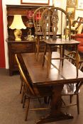 Eight piece Ercol dining room suite comprising shelf back dresser, draw leaf table and six chairs.