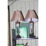 Pair of gilt and mirrored table lamps with silk shades.