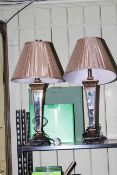 Pair of gilt and mirrored table lamps with silk shades.