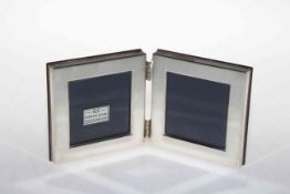 Silver hinged double photograph frame.