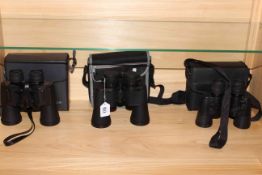 Three pairs of binoculars including Minolta, Bresser and Optica.