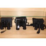 Three pairs of binoculars including Minolta, Bresser and Optica.