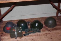 Four assorted military helmets, belt and ammo box.