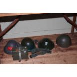Four assorted military helmets, belt and ammo box.