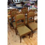 Set of four walnut side chairs with carved decoration.