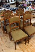 Set of four walnut side chairs with carved decoration.