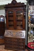 Late Victorian carved oak bureau bookcase, 2.43m high, 1.07m wide and 0.51m deep.