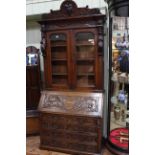 Late Victorian carved oak bureau bookcase, 2.43m high, 1.07m wide and 0.51m deep.