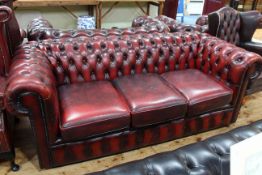 Red leather deep buttoned Chesterfield three seater sofa.