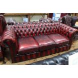 Red leather deep buttoned Chesterfield three seater sofa.