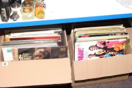 Two boxes of LP records and singles.