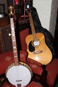 Westfield acoustic guitar and banjo with cases.