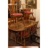 Oak finish rectangular kitchen table and six matching chairs.