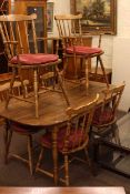 Oak finish rectangular kitchen table and six matching chairs.