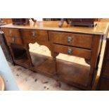 Oak dresser with potboard base and lion and mask handles, 1.7m wide.