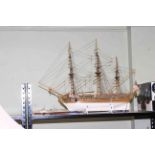 Wooden model of a gun ship and small model of navy warship.