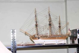 Wooden model of a gun ship and small model of navy warship.