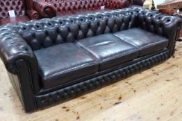 Leather deep buttoned Chesterfield four seater sofa.