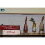 Two Coca Cola crates and three wooden ducks.