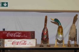 Two Coca Cola crates and three wooden ducks.