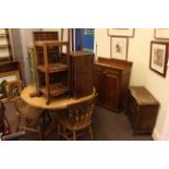 Circular pine table, three farmhouse chairs, mahogany cupboard, small oak chest, print block tray,