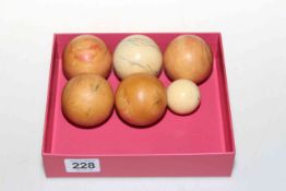 Five vintage ivory snooker balls and one smaller ball (5).